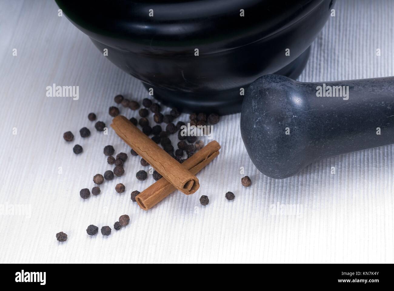 black stone mortar and pestel with cinnamon and pepper Stock Photo Alamy