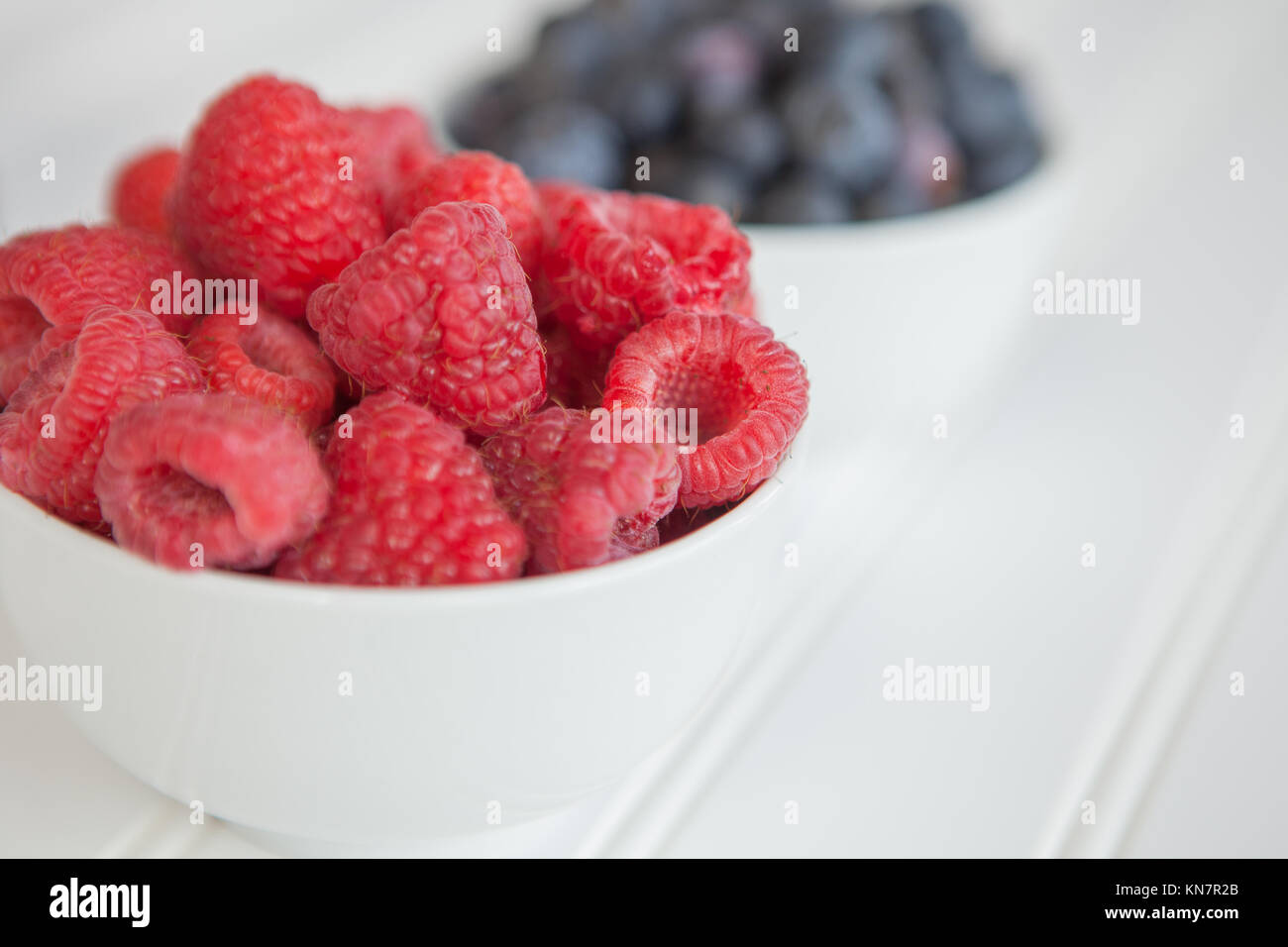 Bowls of blueberries and raspberries Stock Photo