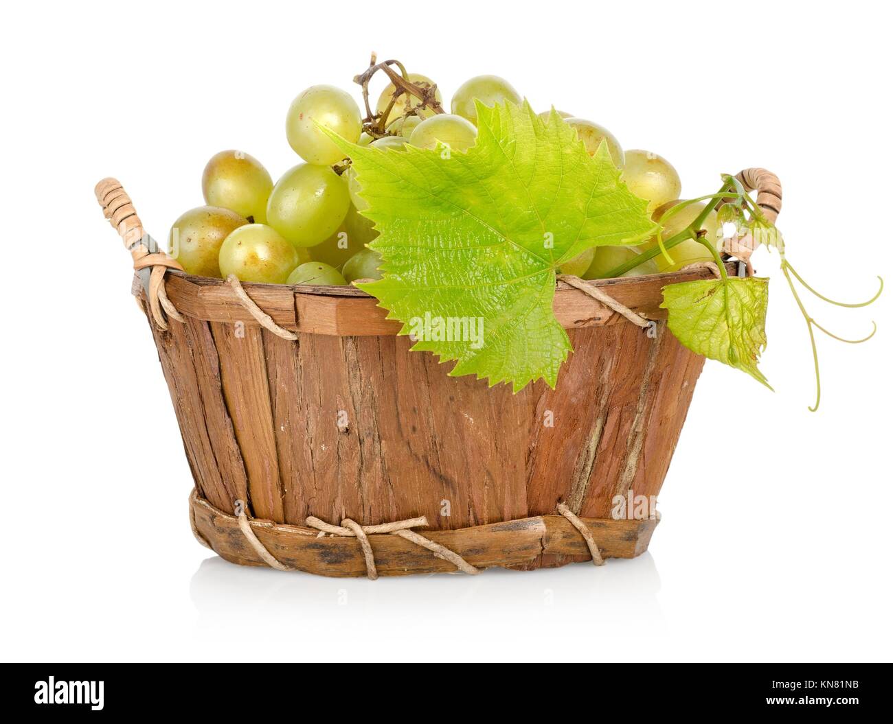 Grapes in a wooden basket isolated on white background. Stock Photo