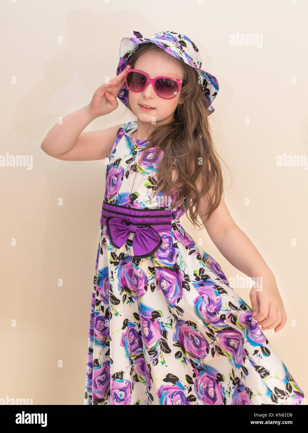 Pretty teen girl in dress with sunglases and hat. Stock Photo