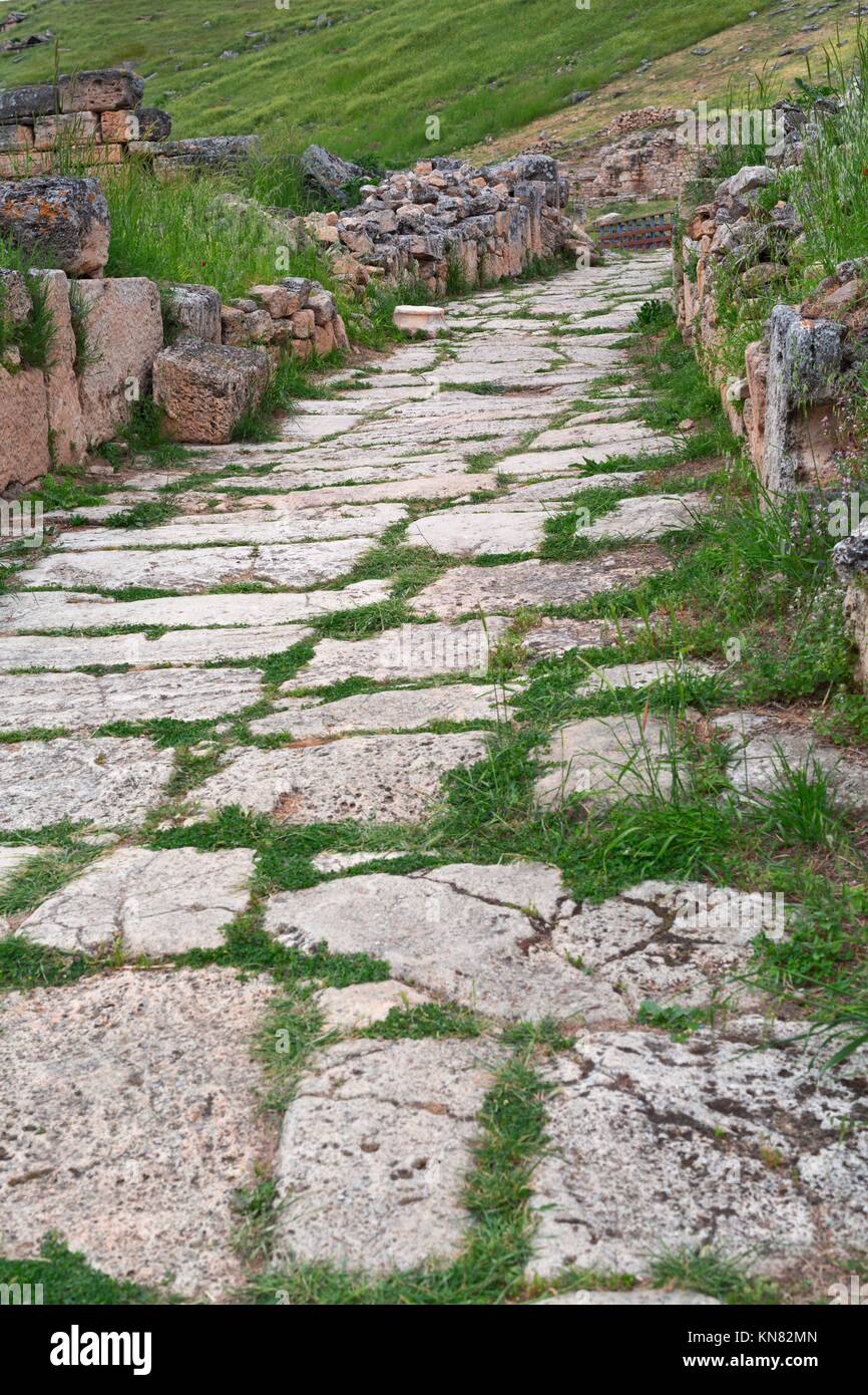 Old paved road with natural stone plates. Stock Photo