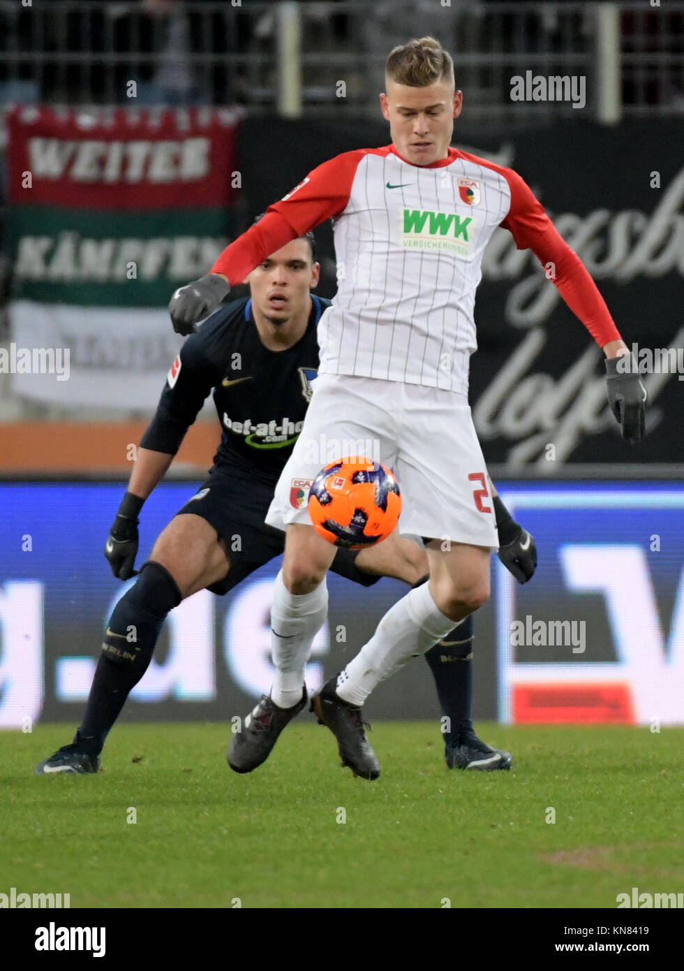 Augsburg, Germany. 10th Dec, 2017. Augsburg's Alfred Finnbogason (front) and Karim Rekik of Berlin vie for the ball during the German Bundesliga football match between FC Augsburg and Hertha BSC at the WWK-Arena in Augsburg, Germany, 10 December 2017. (EMBARGO CONDITIONS - ATTENTION: Due to the accreditation guidelines, the DFL only permits the publication and utilisation of up to 15 pictures per match on the internet and in online media during the match.) Credit: Stefan Puchner/dpa/Alamy Live News Stock Photo