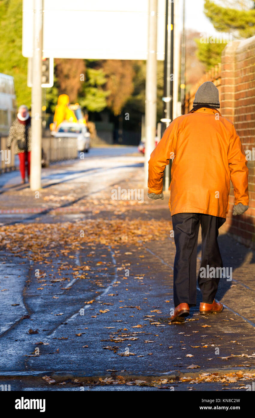 Dundee, UK. 11th December, 2017. UK Weather: Arctic blast brings icy conditions across Tayside. While most of Britain has had snow blizzards, Dundee is hit by the Big Freeze with temperatures well below freezing (-2°C). An elderly man wrapped up warm from the cold weather out for a morning stroll in the cold sunshine. Credits: Dundee Photographics/Alamy Live News Stock Photo
