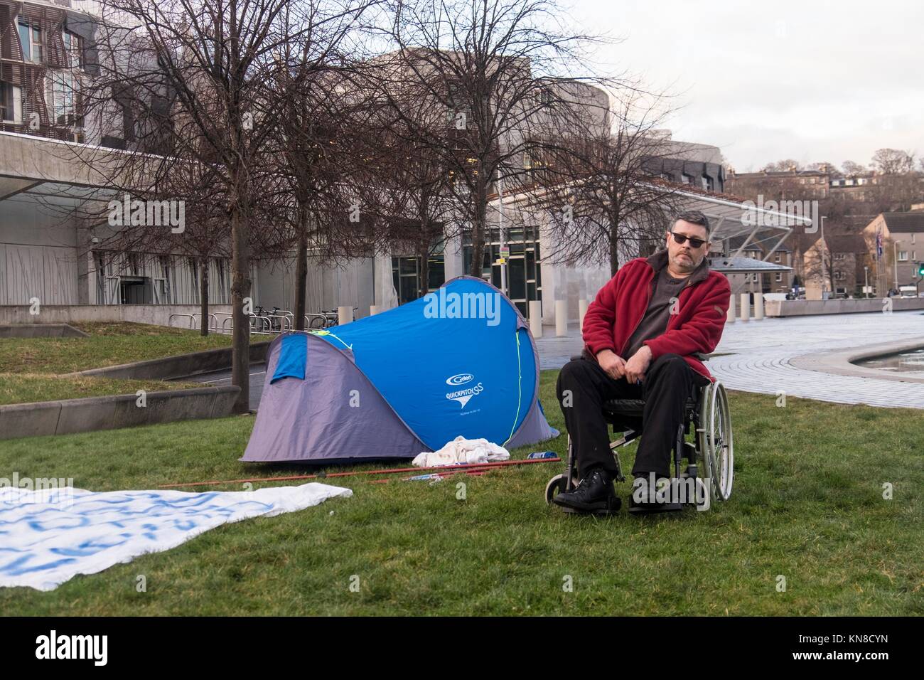 Edinburgh, UK. 11th December, 2017. Campaigner, Ian Morrison from Kilwinning in Ayrshire has set up a tent in the grounds of the Scottish Parliament and has threatened to carry out a hunger strike until he is allowed to meet with SNP Health Minister, Shona Robison.  Morrison's campaign relates to the use of opioids in treatment in the Scottish NHS where drug related general acute stays have increased from 41 people to 143 people per 100k between 1996 and 2016. Credit: Rich Dyson/Alamy Live News Stock Photo