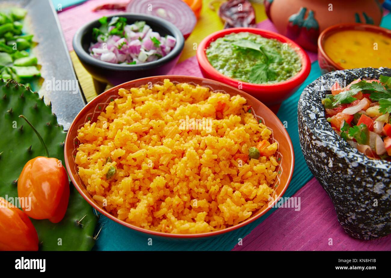 Mexican yellow rice with chilis and sauces in colorful background Stock Photo Alamy