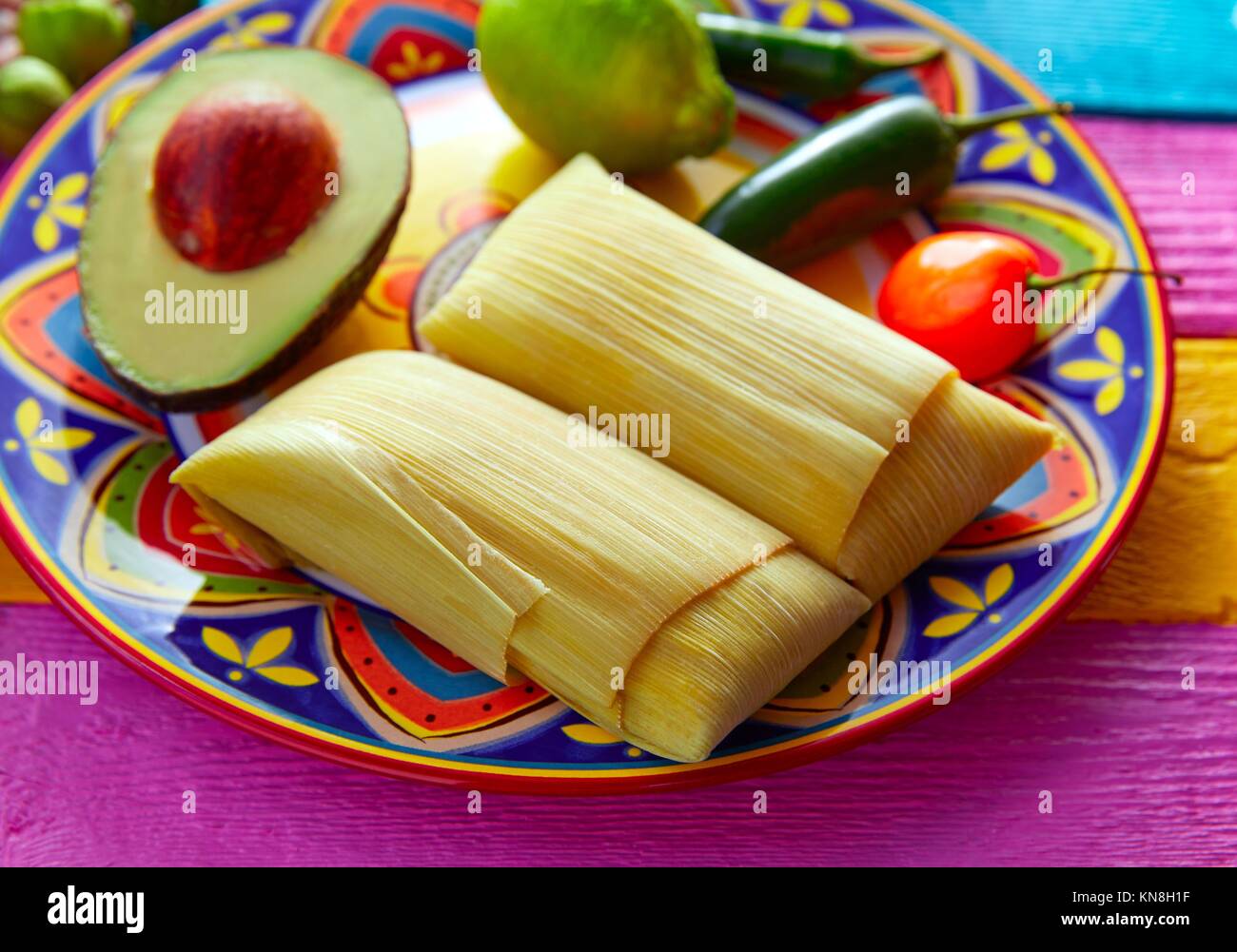 Mexican Tamale tamales of corn leaves with chili and sauces Stock Photo