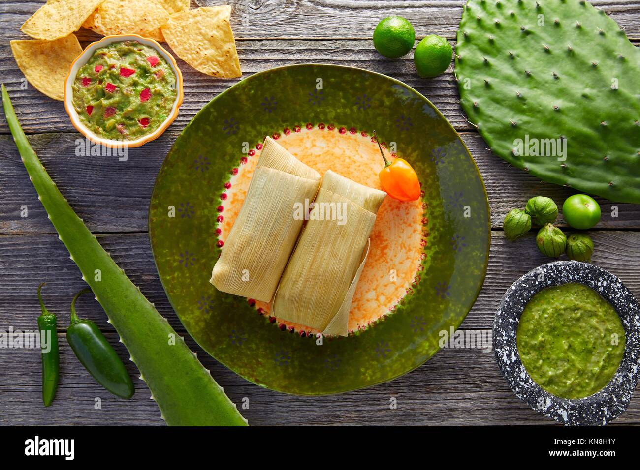 Mexican Tamale tamales of corn leaves with chili and sauces Stock Photo