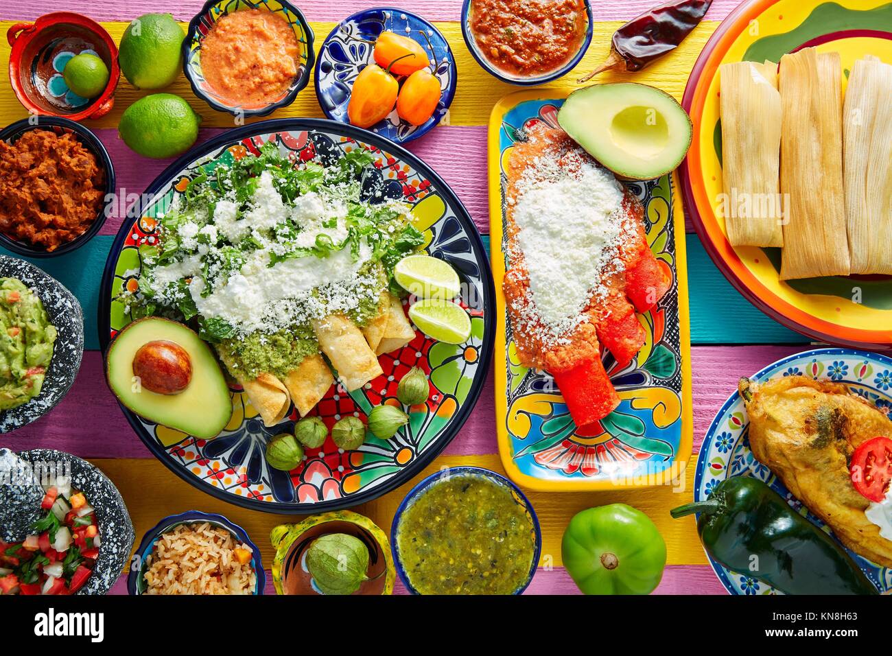 Green and red enchiladas with mexican sauces mix in colorful table Stock Photo Alamy