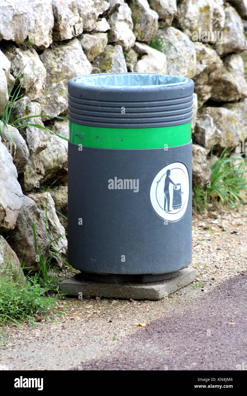 Modern concrete trash can with freshly put nylon bag inside positioned