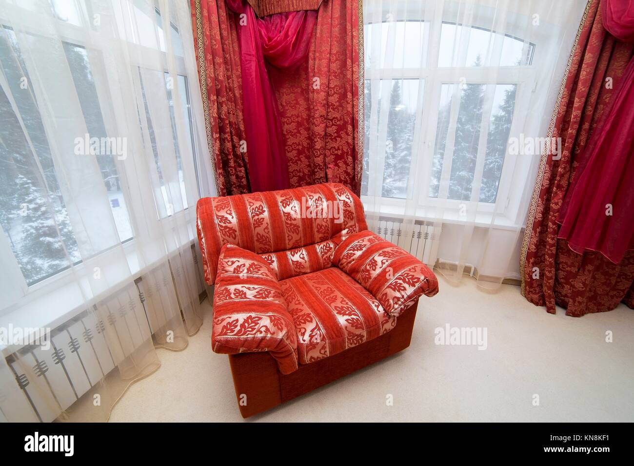 Armchair in classic interior red room house. Stock Photo