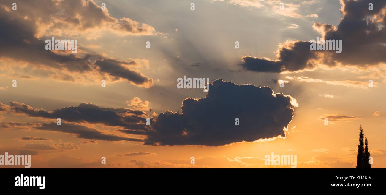 Sky with sun behind the clouds at sunset. Stock Photo