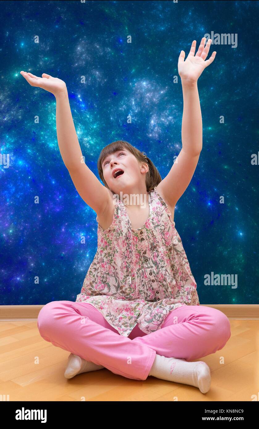 Teenage girl meditating sitting over abstract background. Stock Photo