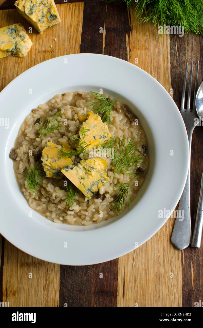 Mushroom risotto with melted blue cheese and dill Stock Photo Alamy
