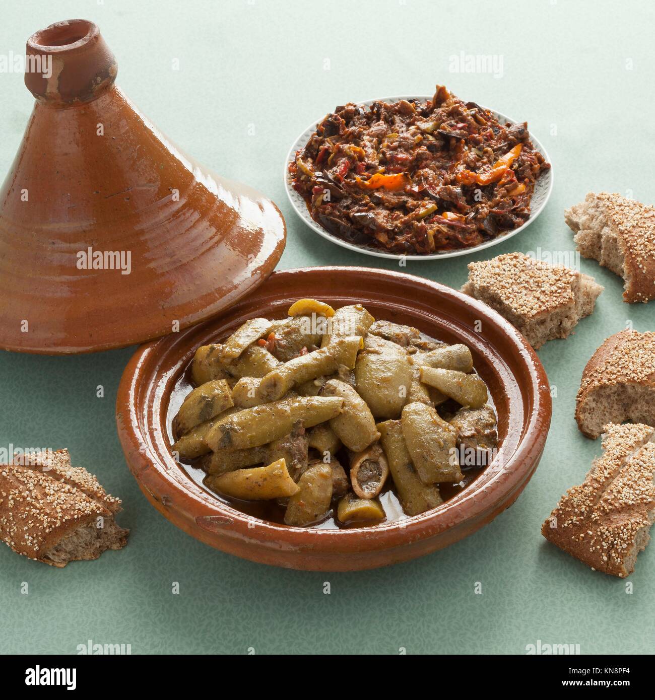 Traditional Moroccan tagine with beef, bottle gourds, bread and salad