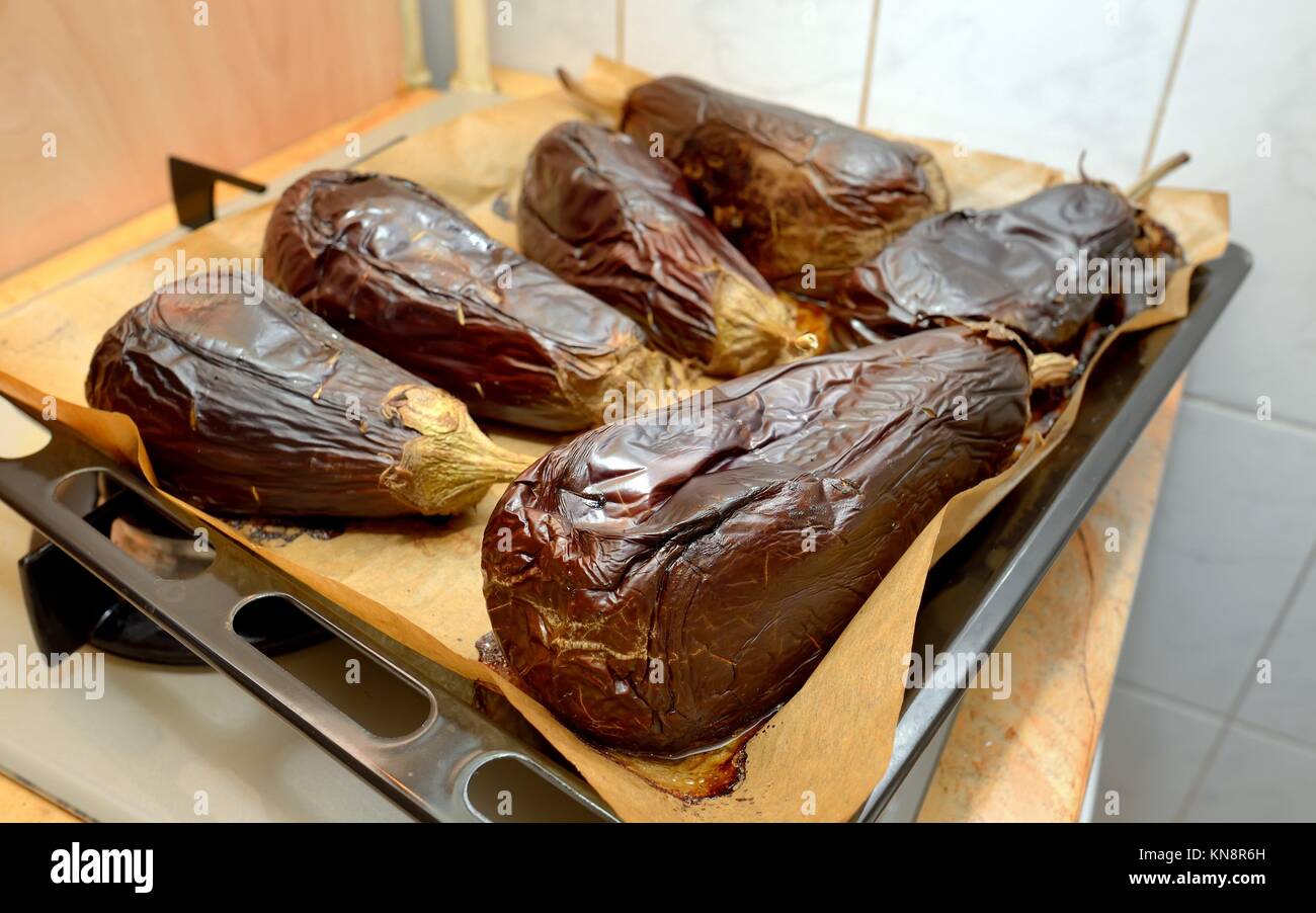 Roasted eggplants cooked in oven tray. Stock Photo