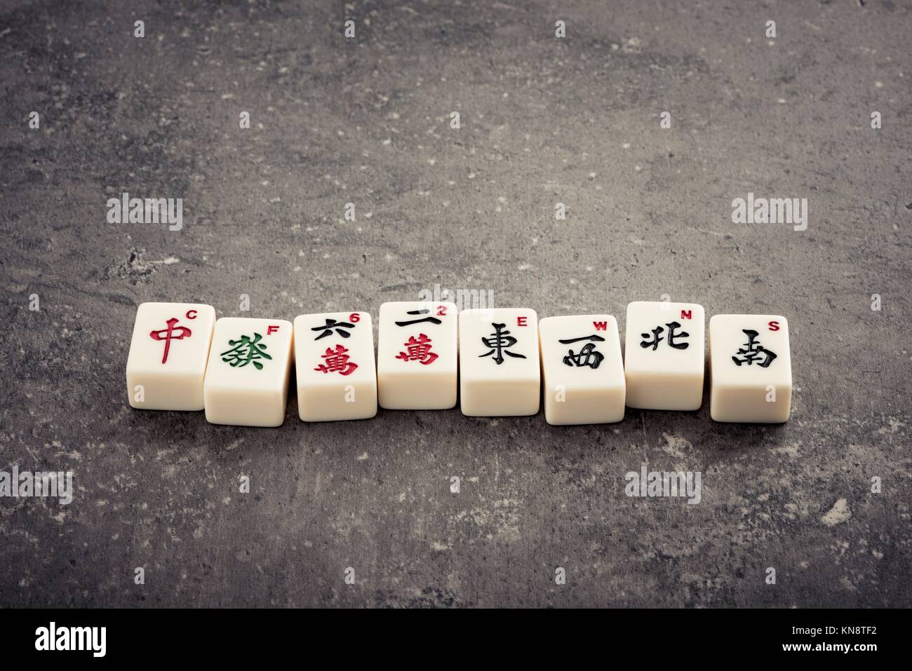Mahjong board game pieces lying on stone table. Concept of asian or chinese  leisure activity, recreation and traditional games Stock Photo - Alamy