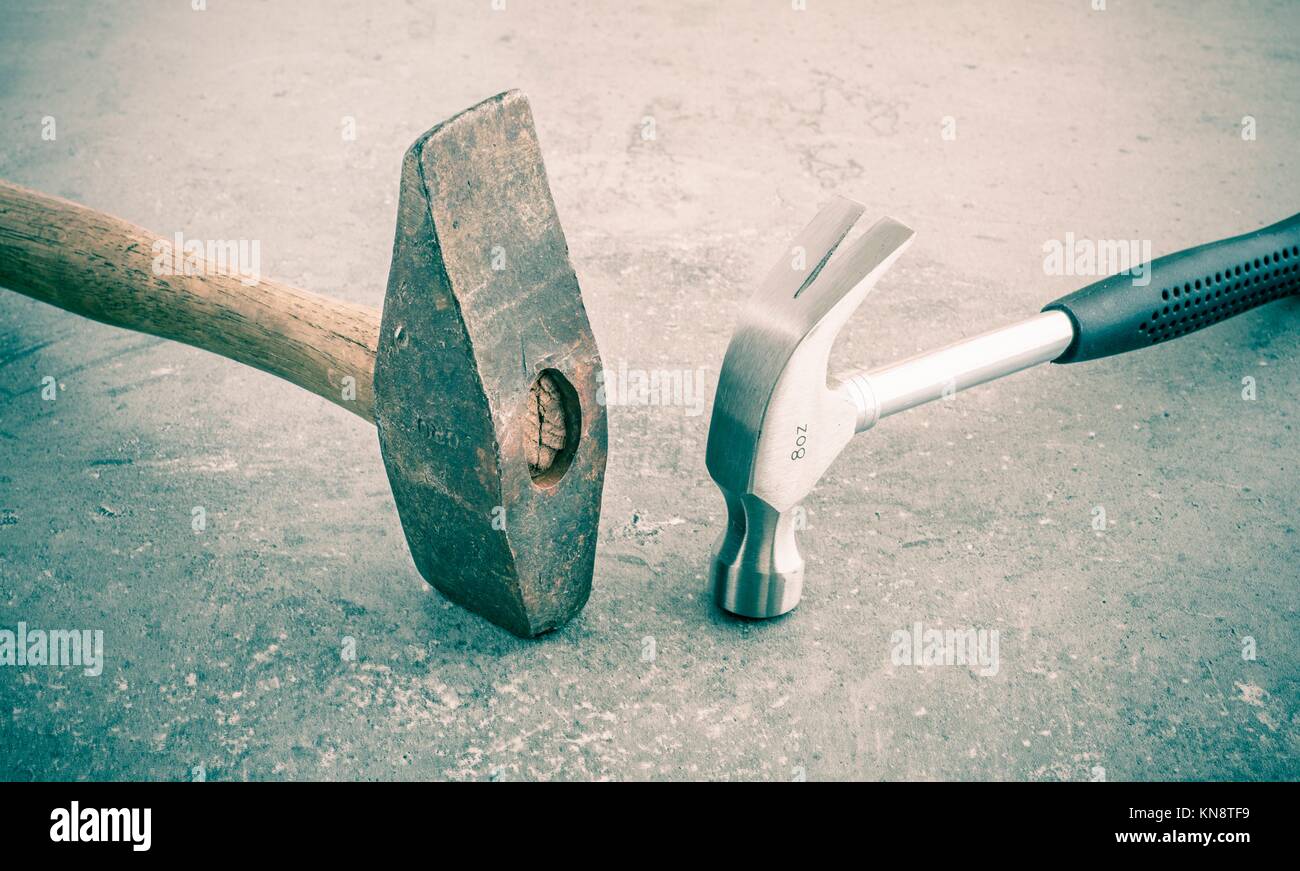 Hammer still life. Two hammers side by side on a stone workbench. Symbol of strength and force. Concept of industrial work tool, carpentry equipment Stock Photo
