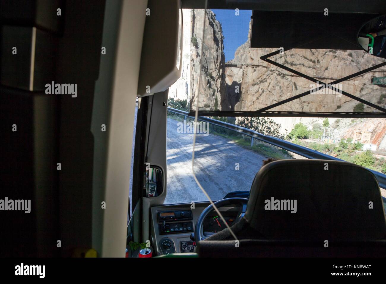 Tourist bus driving on the mountain roads of Gorge of the Gaitanes, Malaga, Spain. Stock Photo