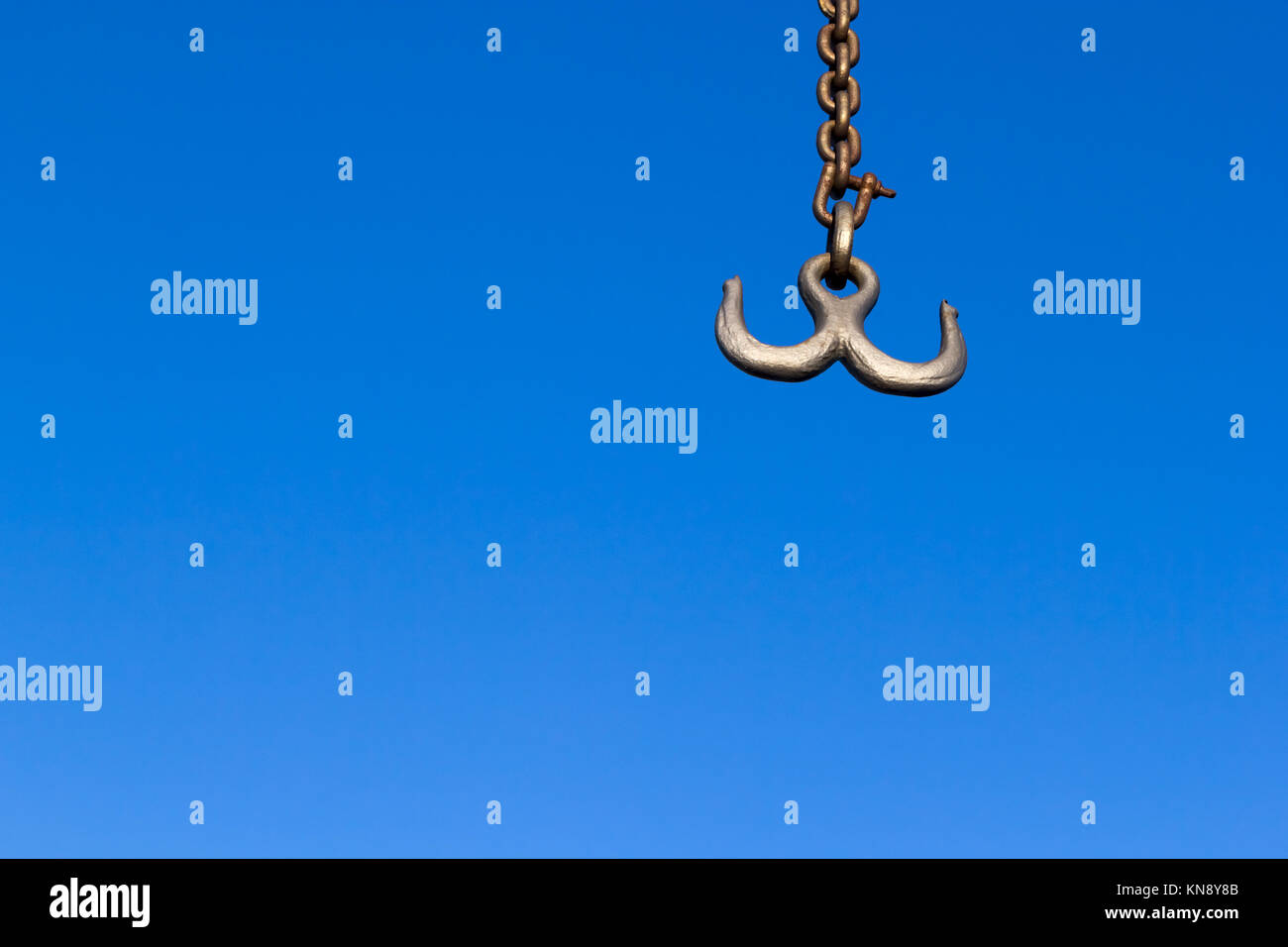 Double hook on a chain against a blue sky Stock Photo