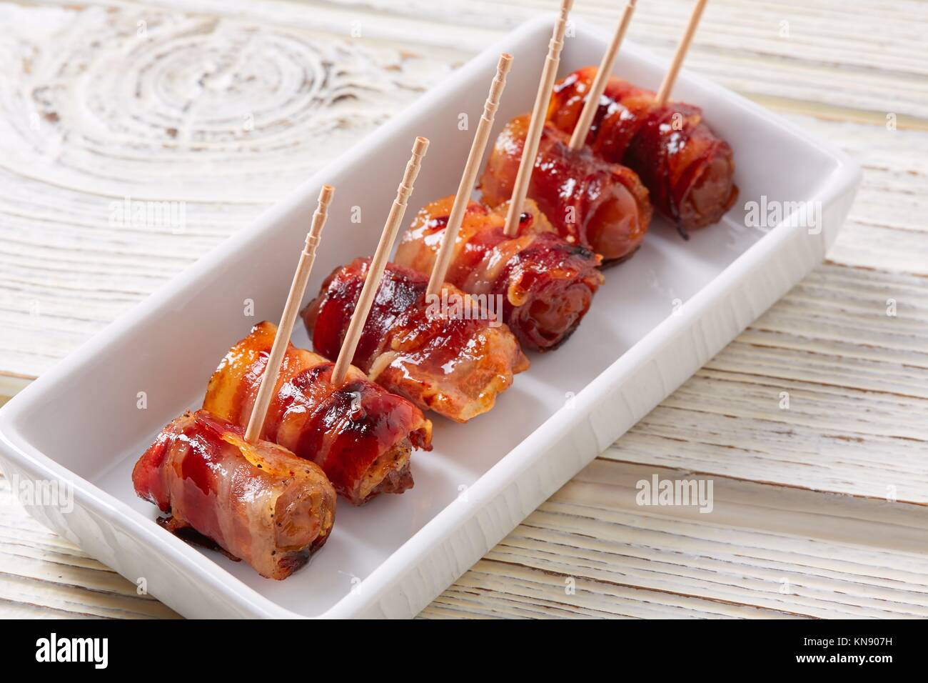 pinchos Bacon wrapped dates pintxos tapas from Spain food Stock Photo