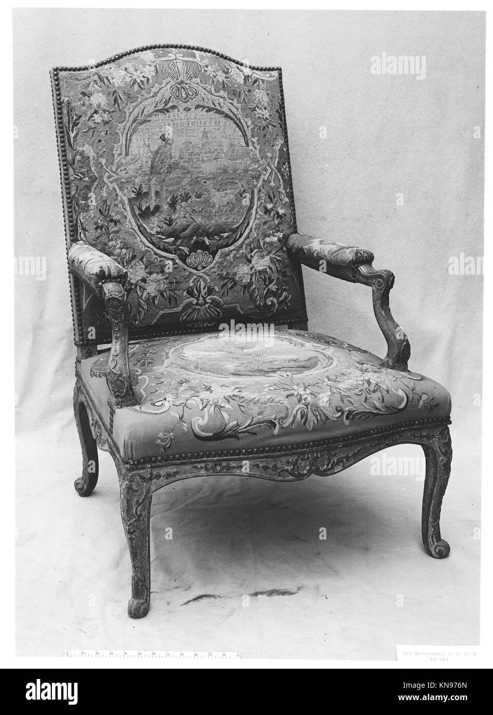 Armchair (fauteuil) MET 4338 Armchair (fauteuil) MET 4338 /189346 Factory: Tapestry woven at Aubusson, Manufacture Royale, est. 1665: Manufacture, ca. 1812?present day, Armchair (fauteuil), first quarter 18th century, Carved walnut, Aubusson tapestry cover, 43 ? 29 1/4 ? 27 in. (109.2 ? 74.3 ? 68.6 cm). The Metropolitan Museum of Art, New York. Gift of J. Pierpont Morgan, 1906 (07.225.61) Stock Photo