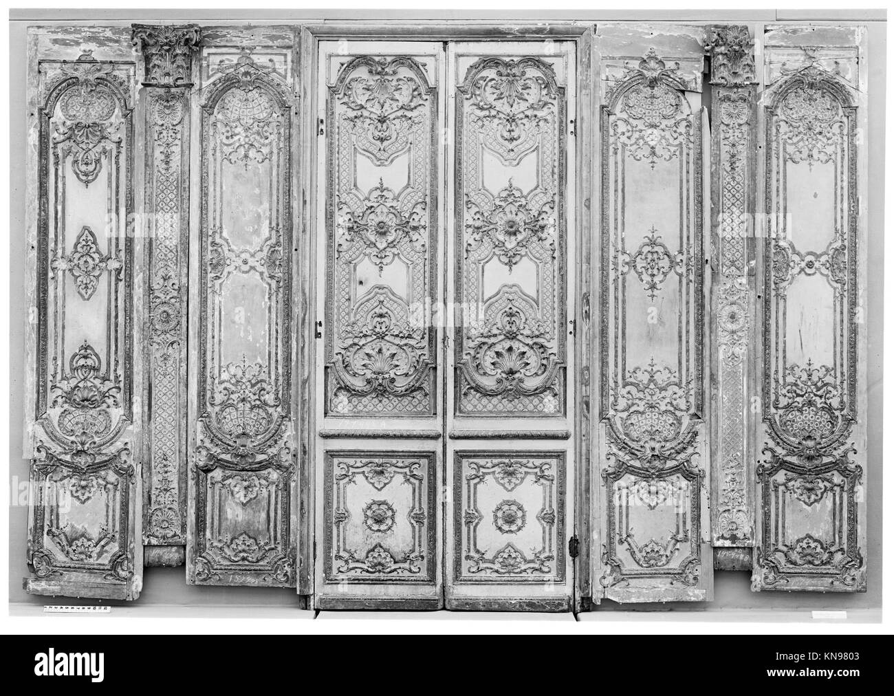 Double door- four panels, two pilasters, three gilt moldings for the door frame MET 4422 Double door- four panels, two pilasters, three gilt moldings for the door frame MET 4422 /189702 French, Double door: four panels, two pilasters, three gilt moldings for the door frame, ca. 1715, Carved, painted and gilded oak, a,b -  doors with their trim i,j,k: 106-1/4 x 53-1/2 in. (269.9 x 135.9 cm) c,e,f,h -  panels:  H. from 102 to 104-3/4 in. (259.1 to 266.1 cm); W. from 20-1/2 to 22 in. (52.1 to 55.9 cm) d - pilaster:  94-1/2 x 12 in. (240 x 30.5 cm) g - pilaster: 94-1/2 x 12-1/2 in. (240 x 31.8 cm) Stock Photo