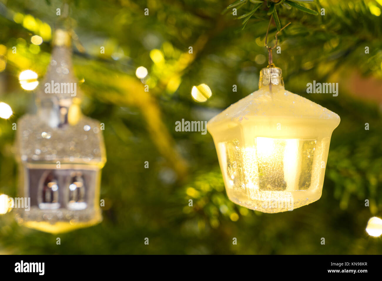 Christmas decoration white and glass lantern hanging in a Nordman christmastree Stock Photo
