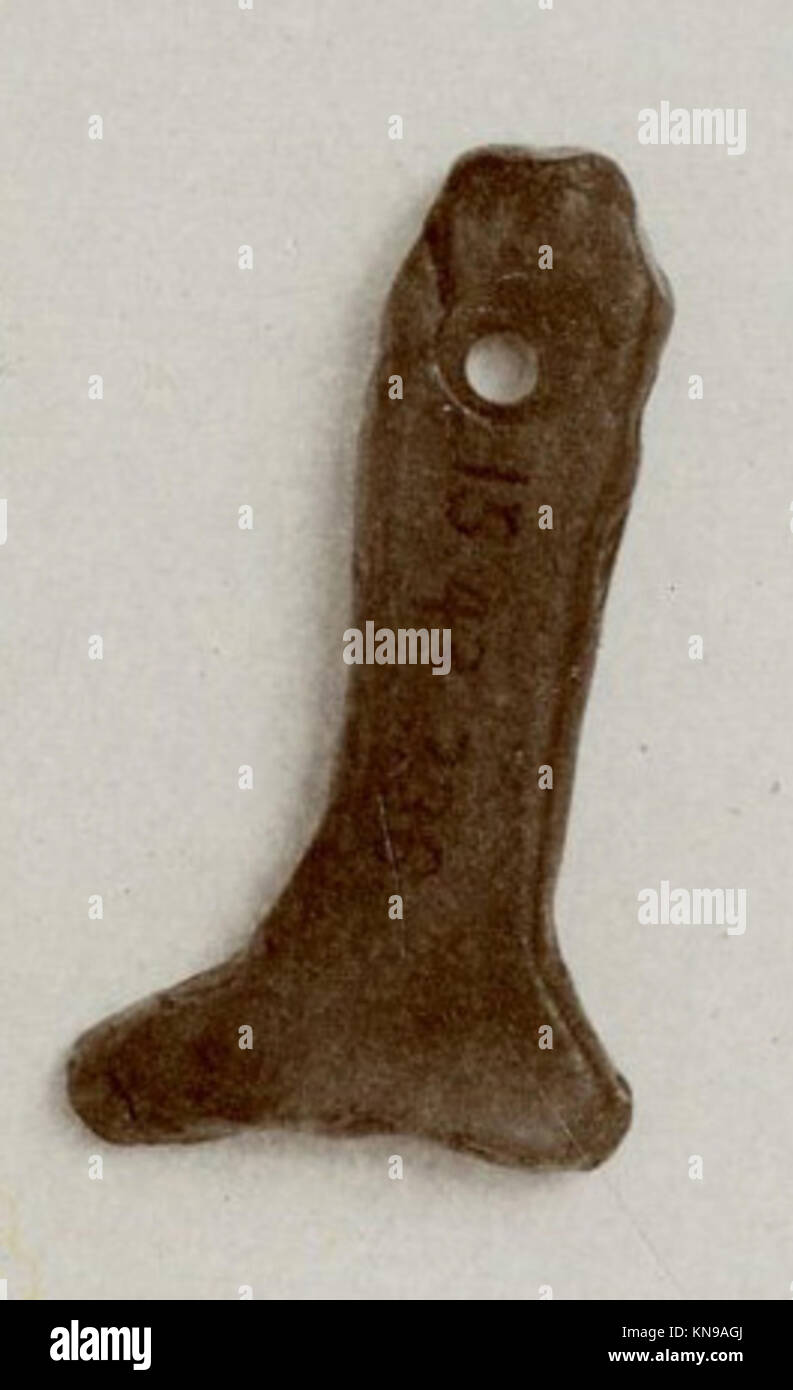 This amulet, shaped like a leg, is an example of ancient jewelry or ...
