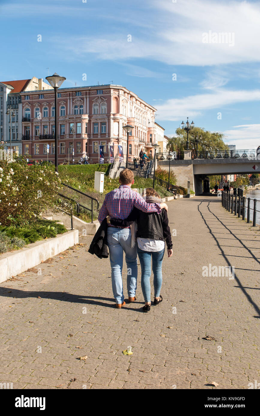people walking  along the banks of the river Brda in the Polish city of Bydgoszcz Poland  enjoying the sunshine Stock Photo