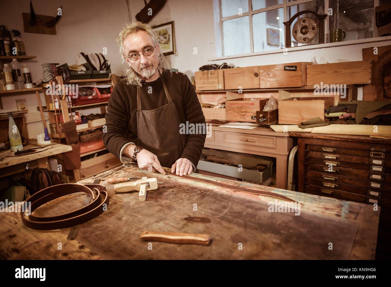 Leather goods craftsman at work in his hires stock