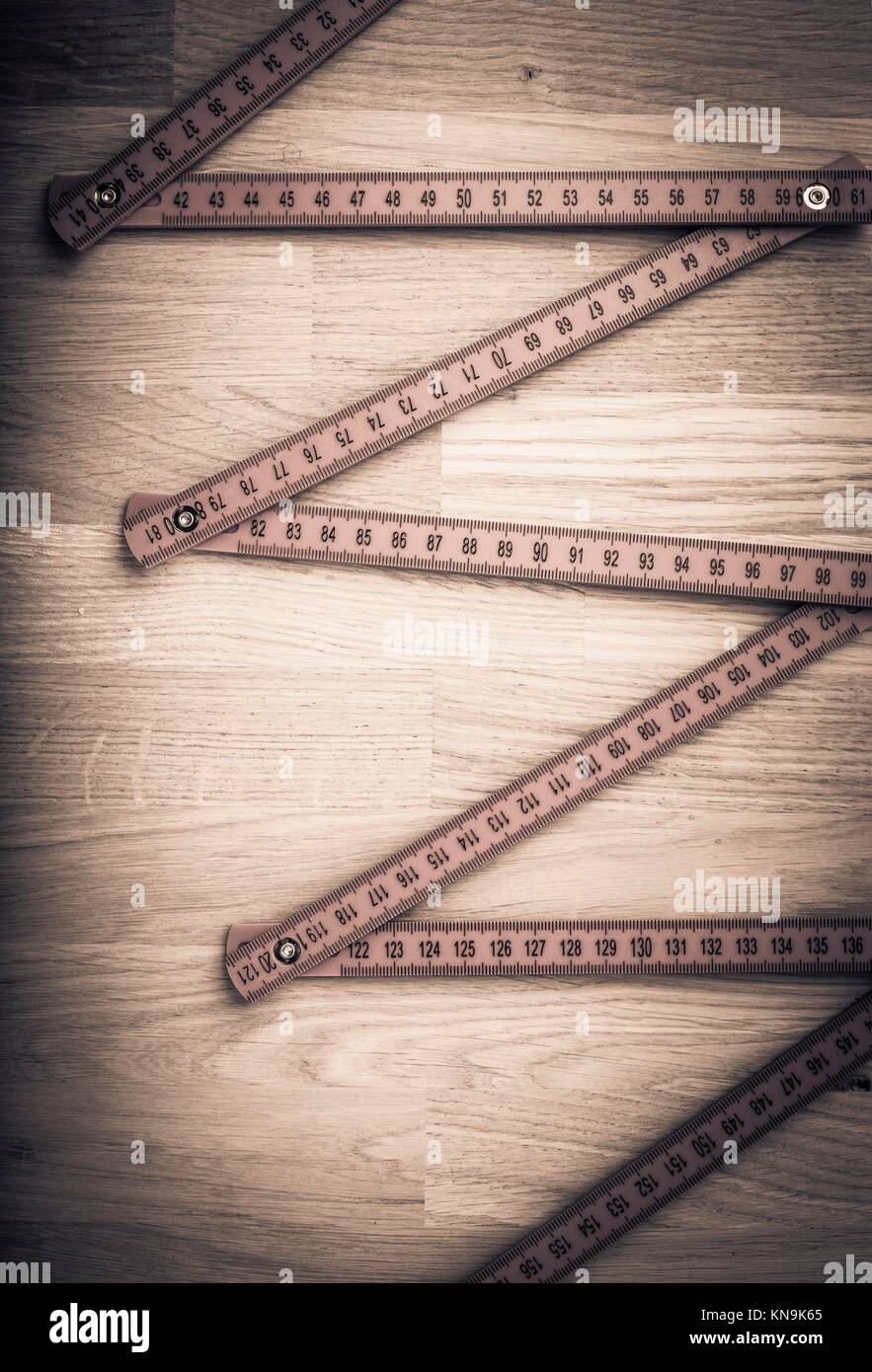 Folding rule on wooden table. Concept image of measurement