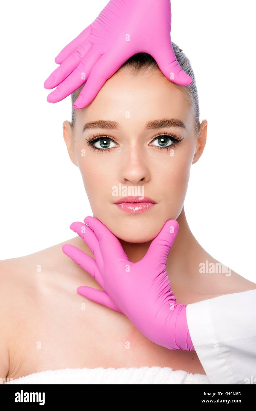 Beautiful face ready for Cosmetic skincare spa beauty treatment with pink gloves, on white. Stock Photo