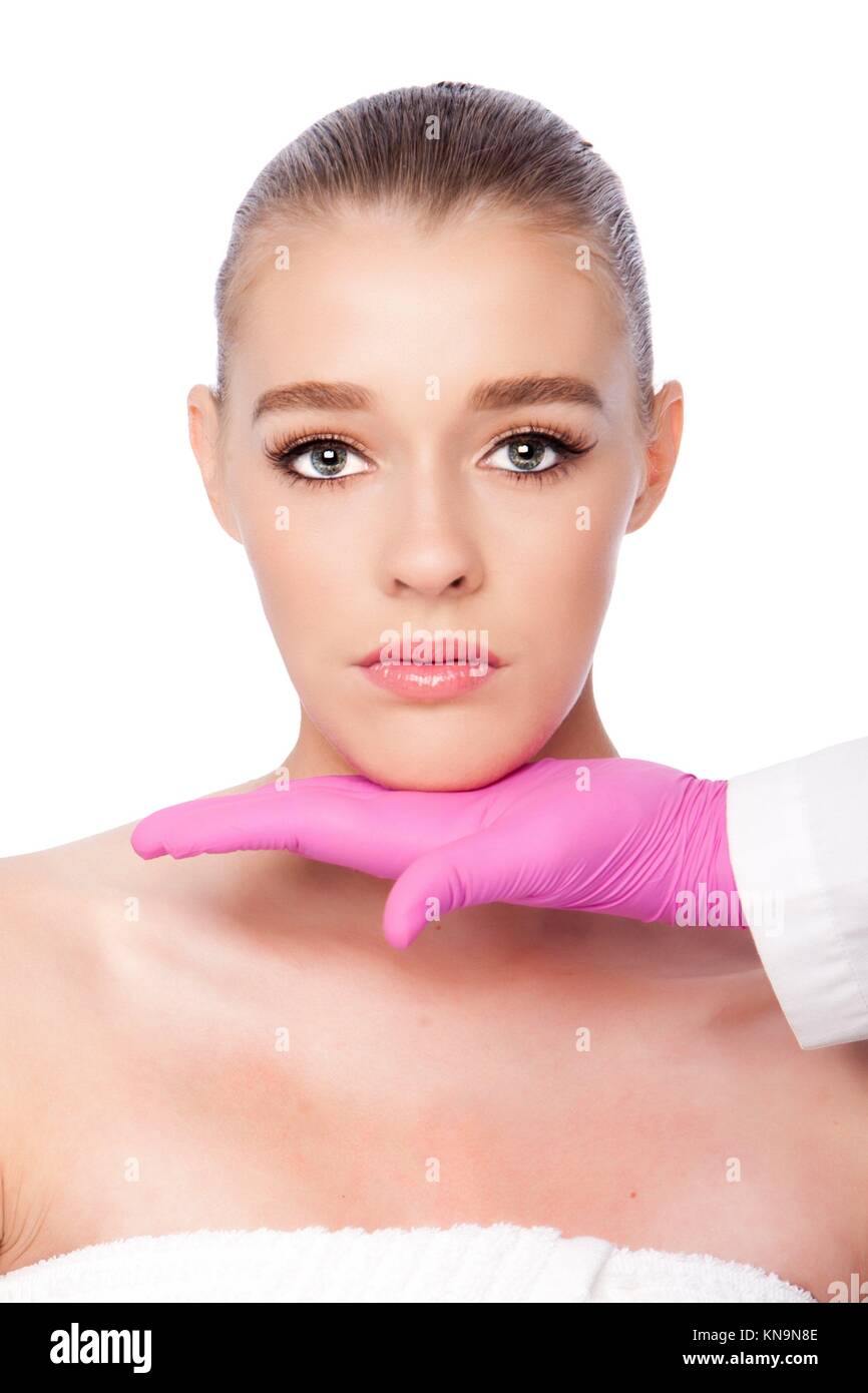 Beautiful face ready for Cosmetic skincare spa beauty treatment with pink glove, on white. Stock Photo