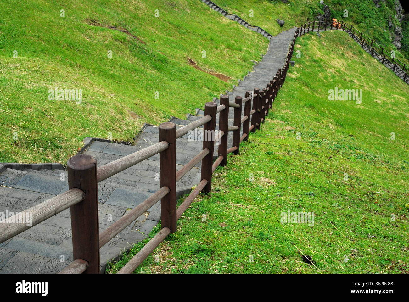 Long flight of stairs with wooden railings leading down. Suitable for concepts such as business and sales, economic downturn, financial crisis, journe Stock Photo