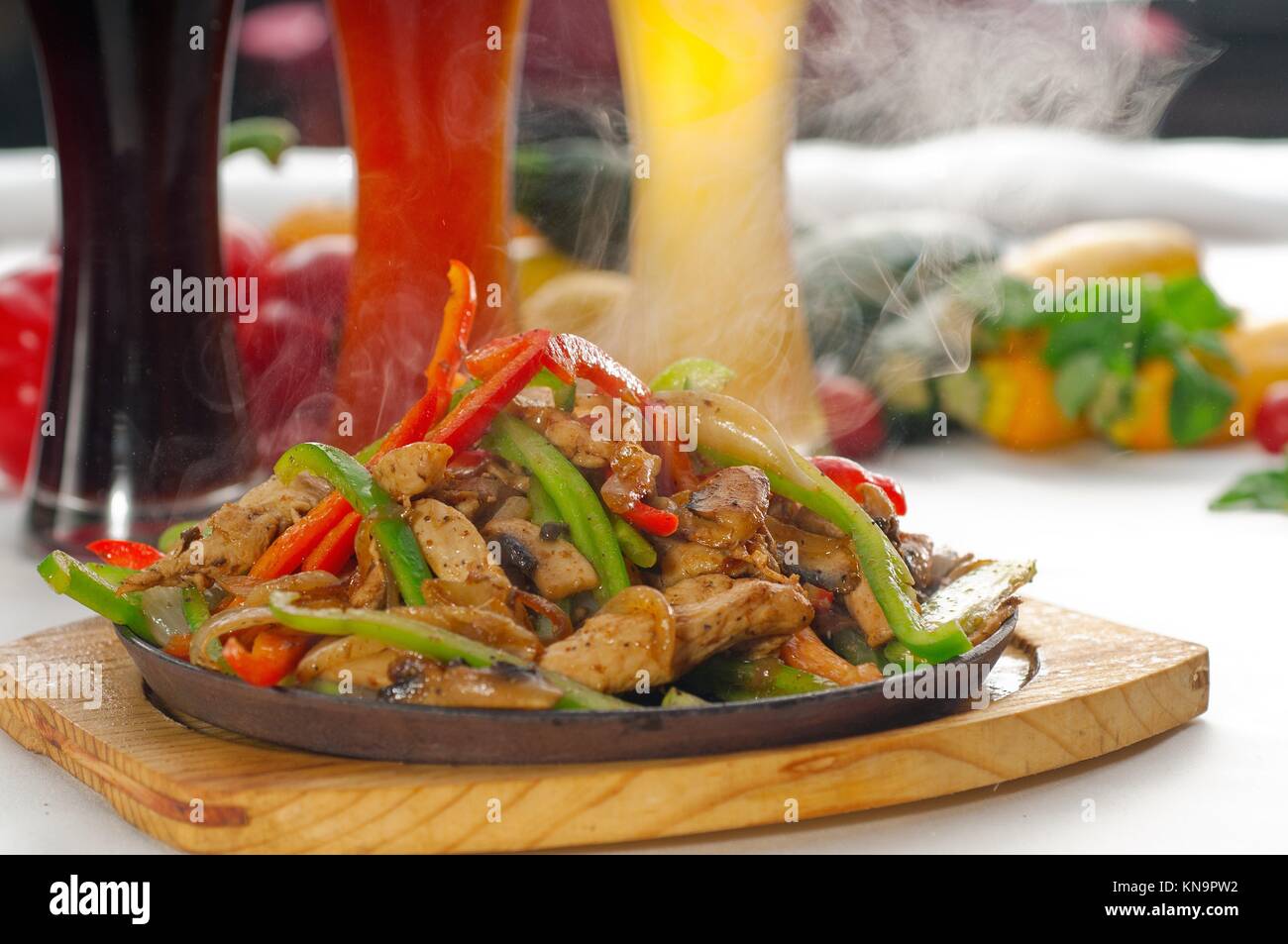 original fajita sizzling smoking hot served on iron plate ,with selection of beer and fresh