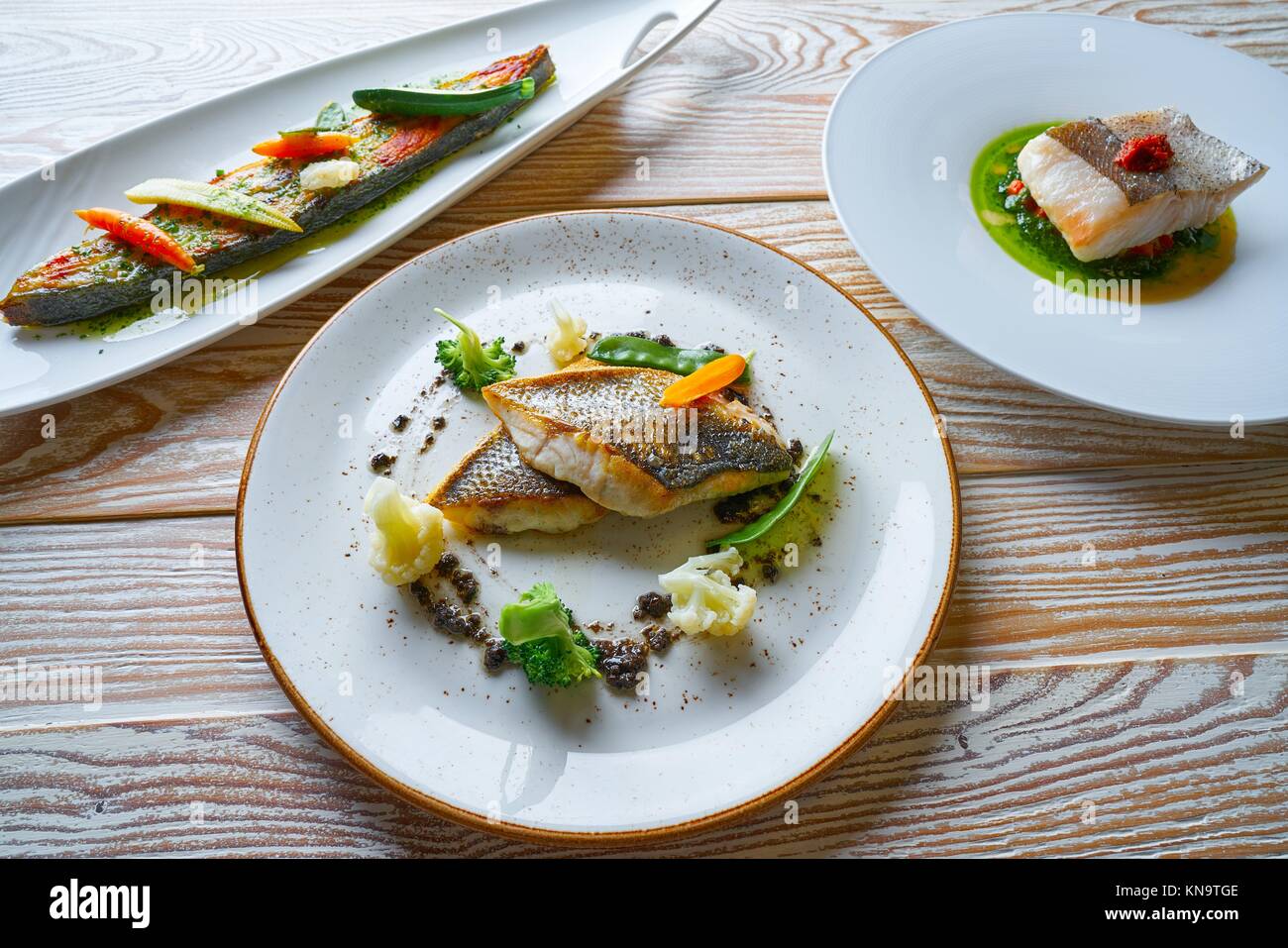 Fish food recipes grilled Turbot Seabass Sea Bass and baked Hake Stock  Photo - Alamy