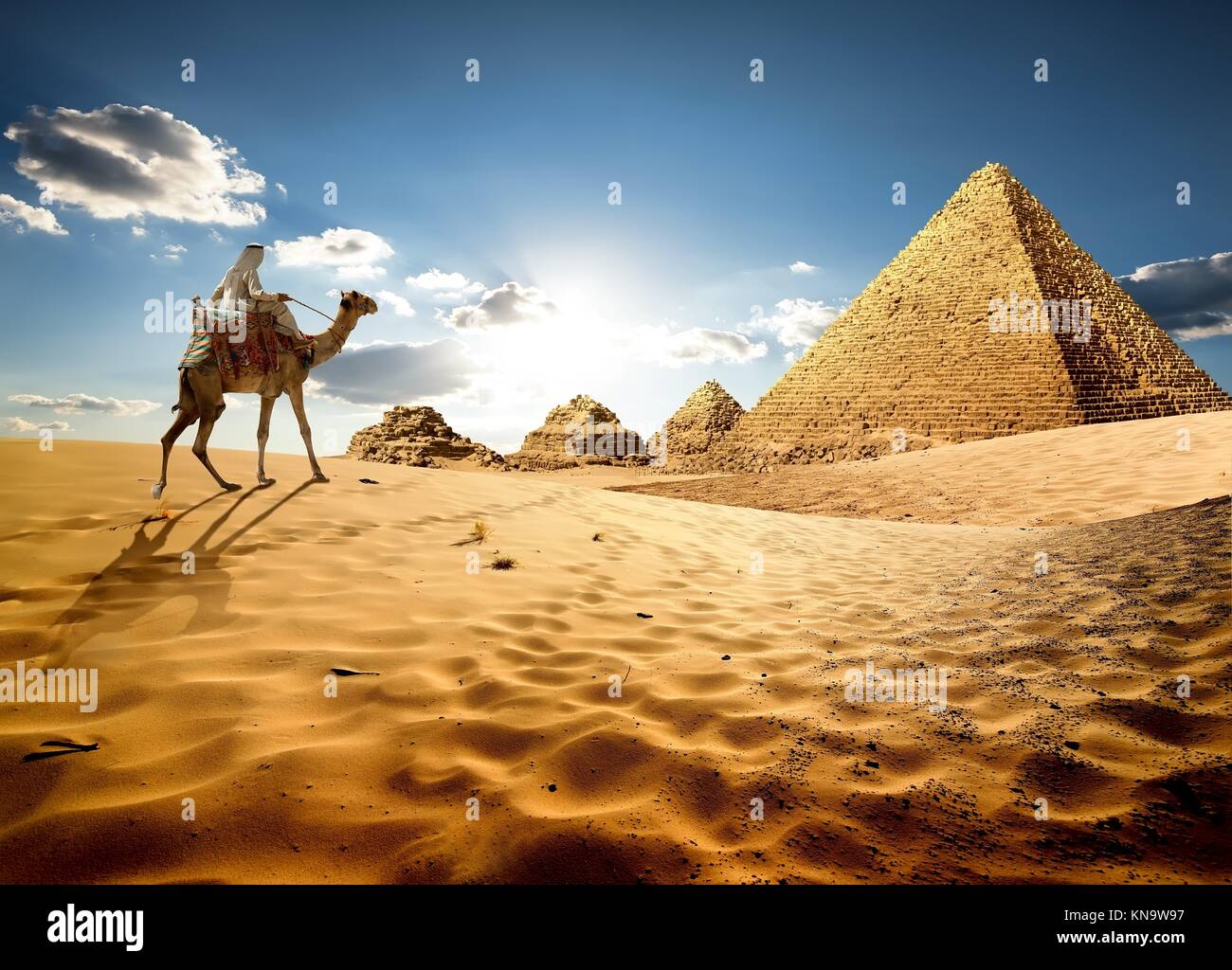 Bedouin On Camel Near Pyramids In Desert Stock Photo Alamy