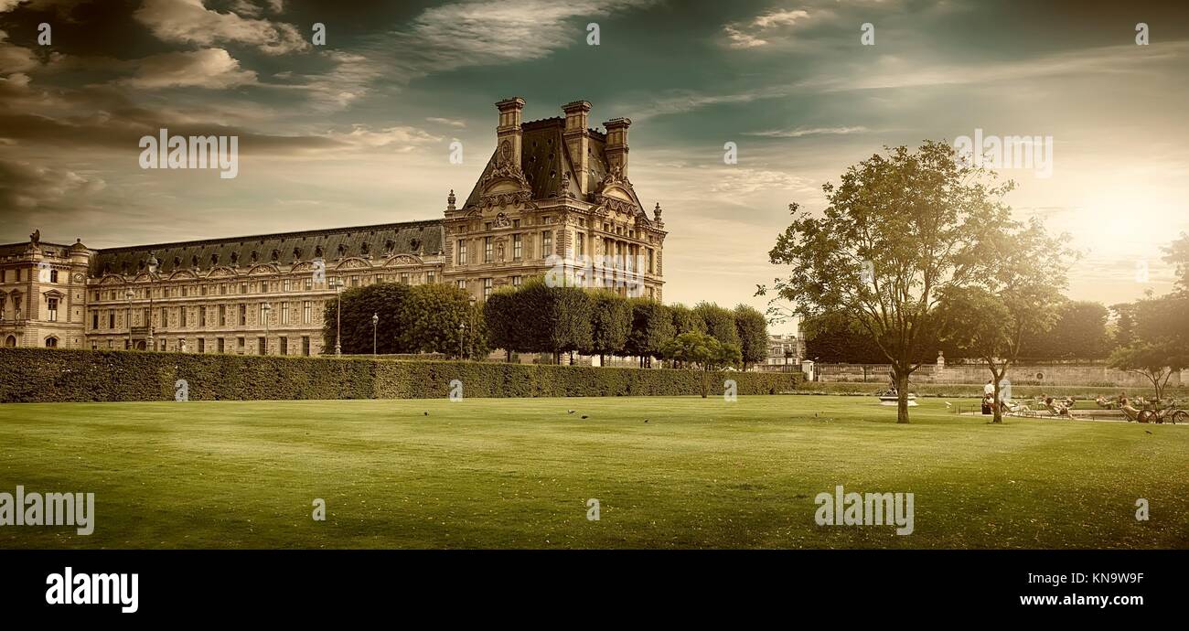 PARIS, FRANCE - AUGUST 26, 2016. View of Louvre Palace and its green park in summer at sunset. Stock Photo