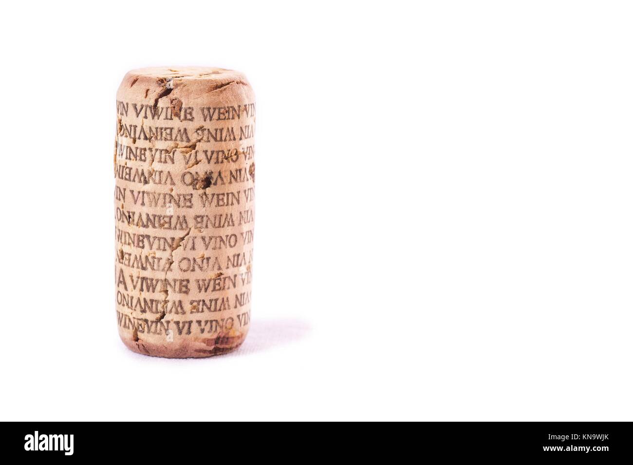Wine cork with word wine in several languages. Isolated. Stock Photo