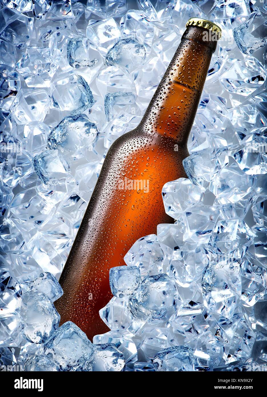 Brown bottle in ice isolated on white. Stock Photo
