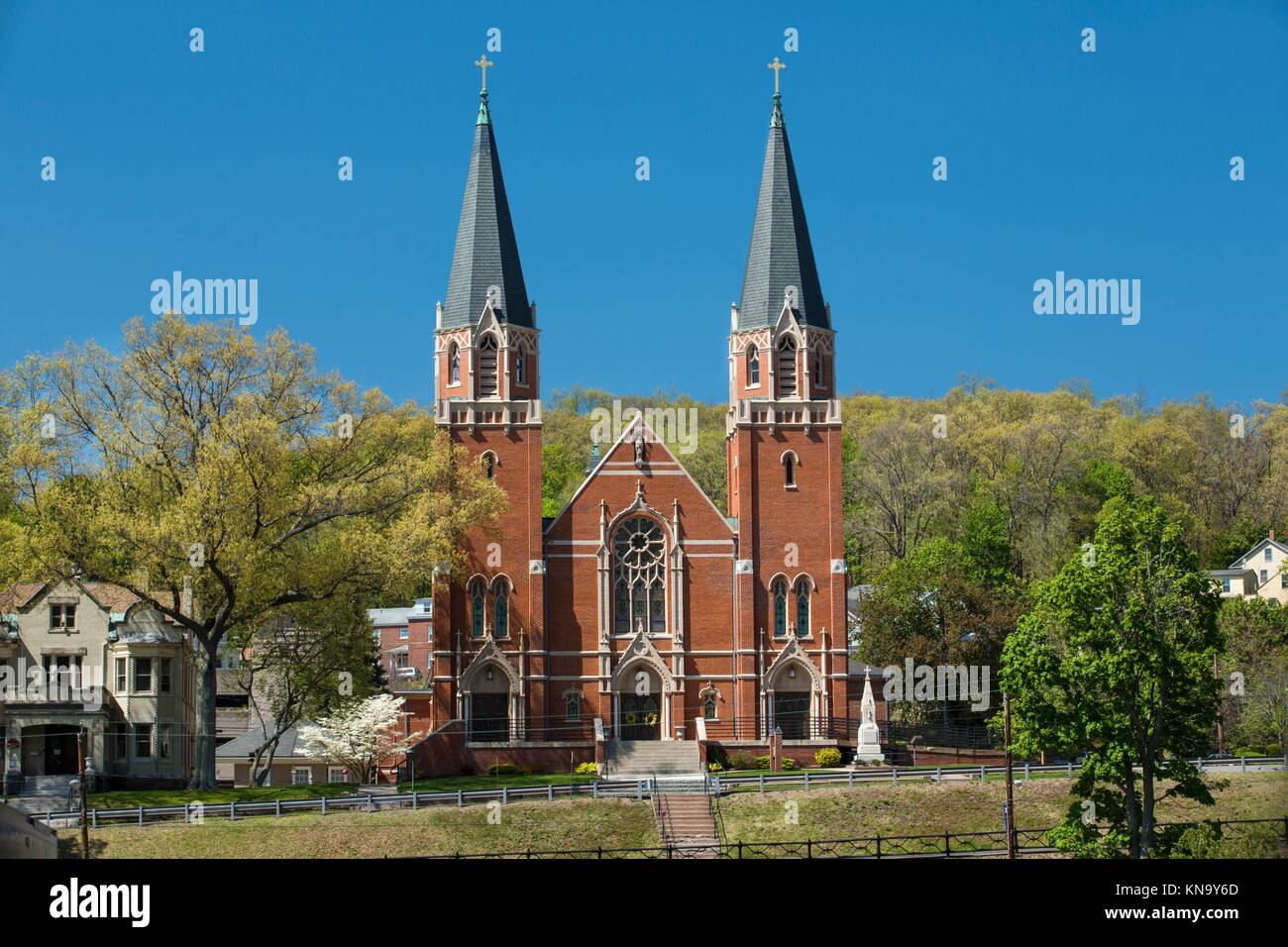 Twin red brick steeples of historic St. Bernard Catholic Church in