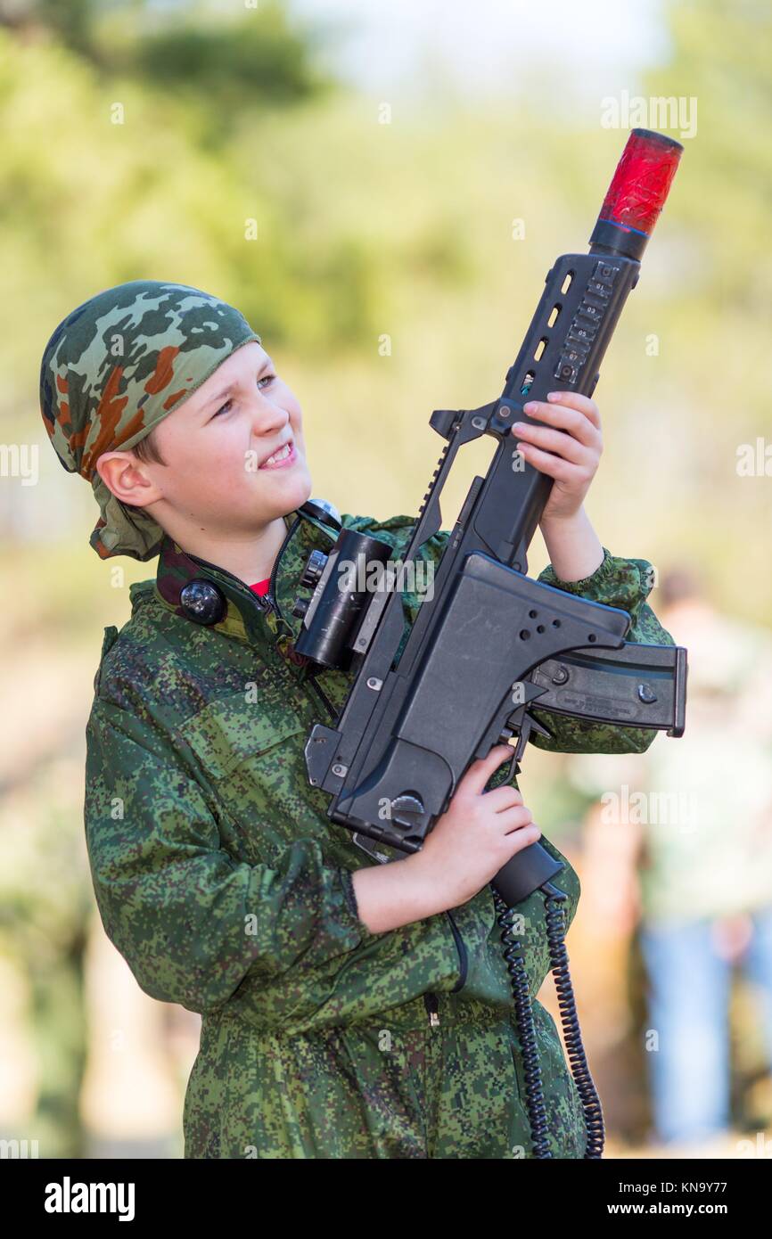 Boy with a gun playing lazer tag open air. Stock Photo