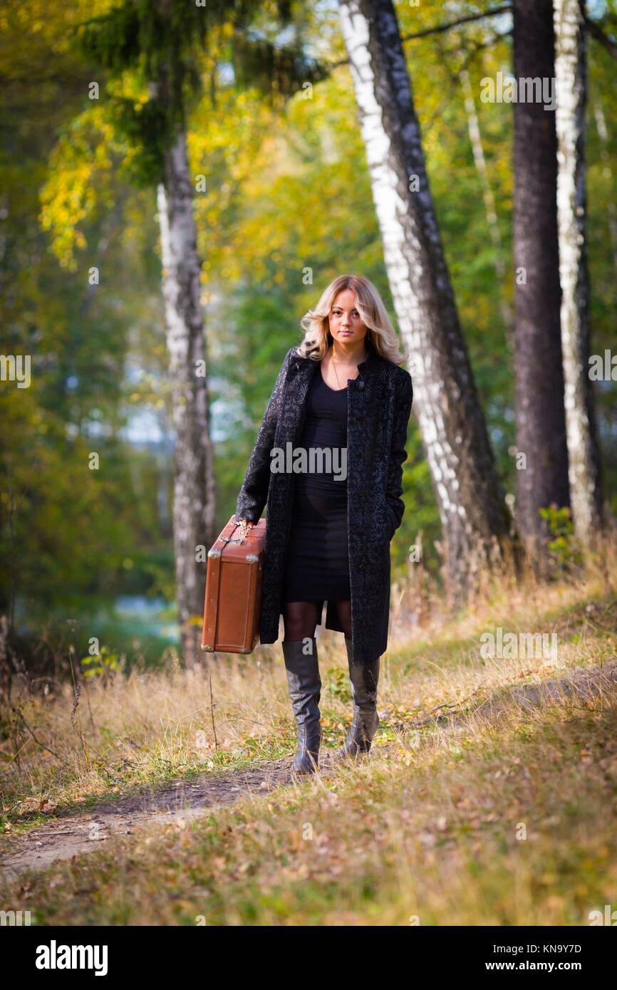 Woman in the park with old fashion trunk retro style. Stock Photo