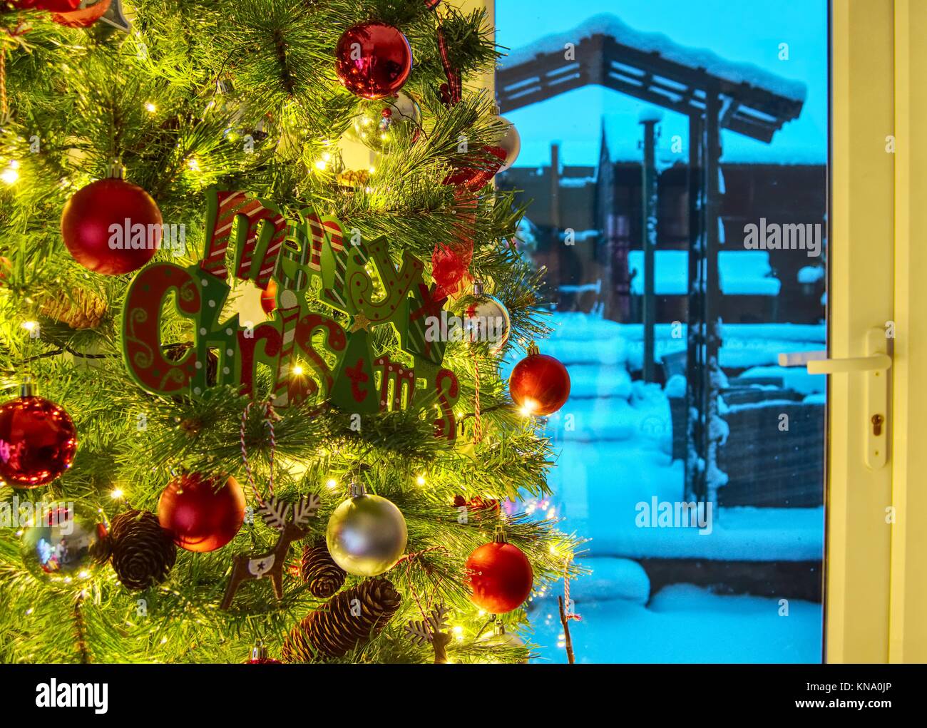 Christmas tree with view of snow outside through the window, Hemel