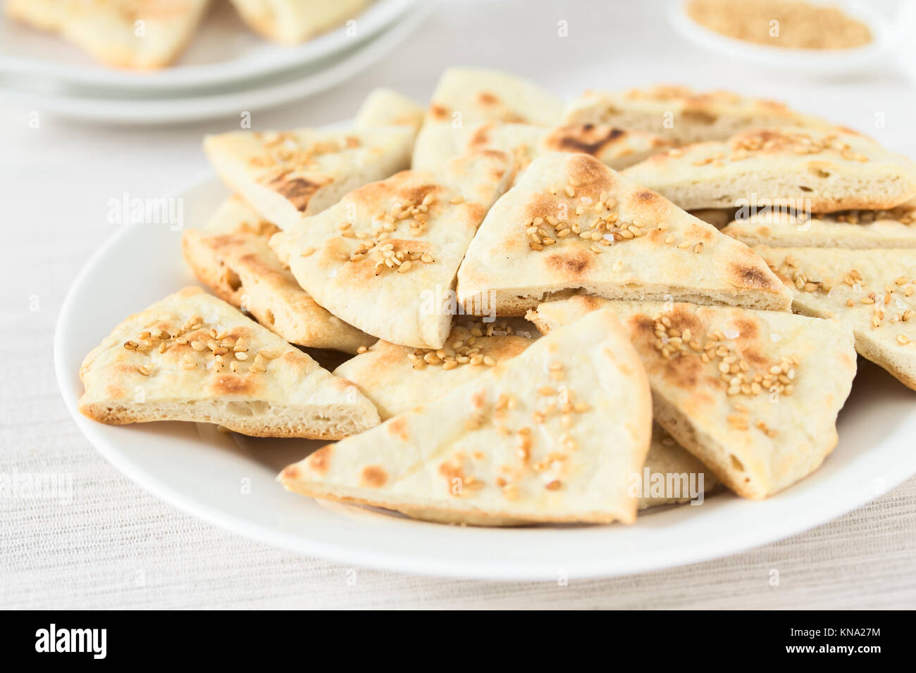 Homemade crispy pita chips with roasted sesame seeds and sea salt