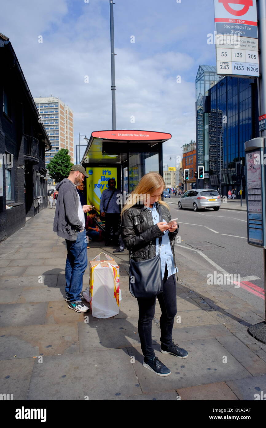 Bus stop uk london woman waiting hi-res stock photography and images ...
