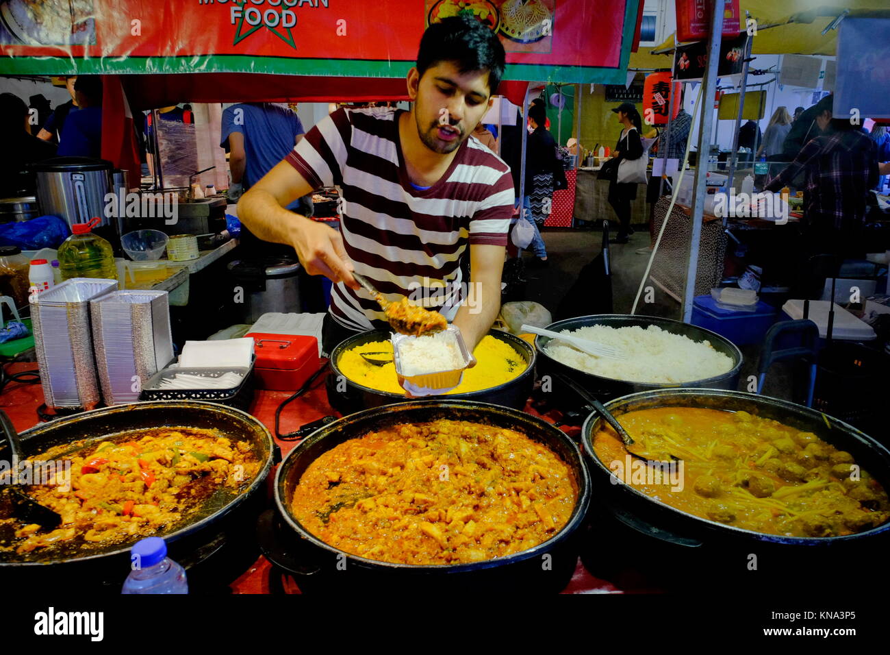 Indian takeaway food in market stall on Brick Lane in Shoreditch, London, England, UK Stock Photo
