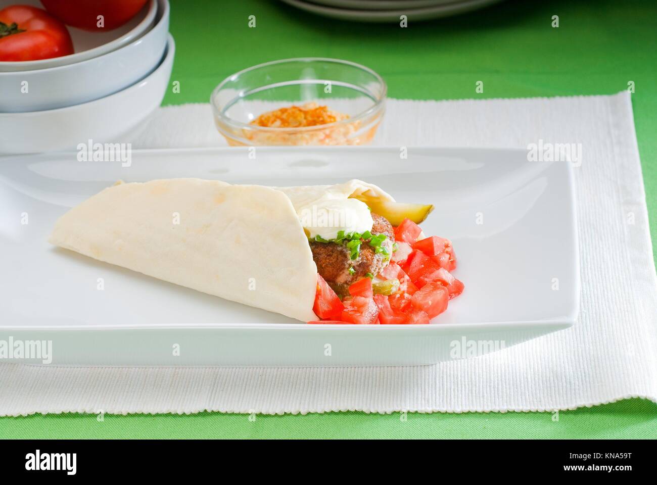 fresh traditional falafel wrap on pita bread with fresh chopped