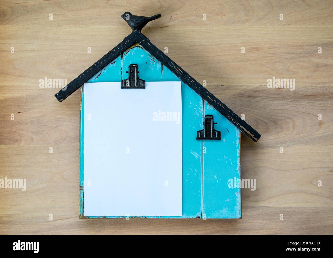 turquoise wooden memo board shaped like a barn with blank paper space