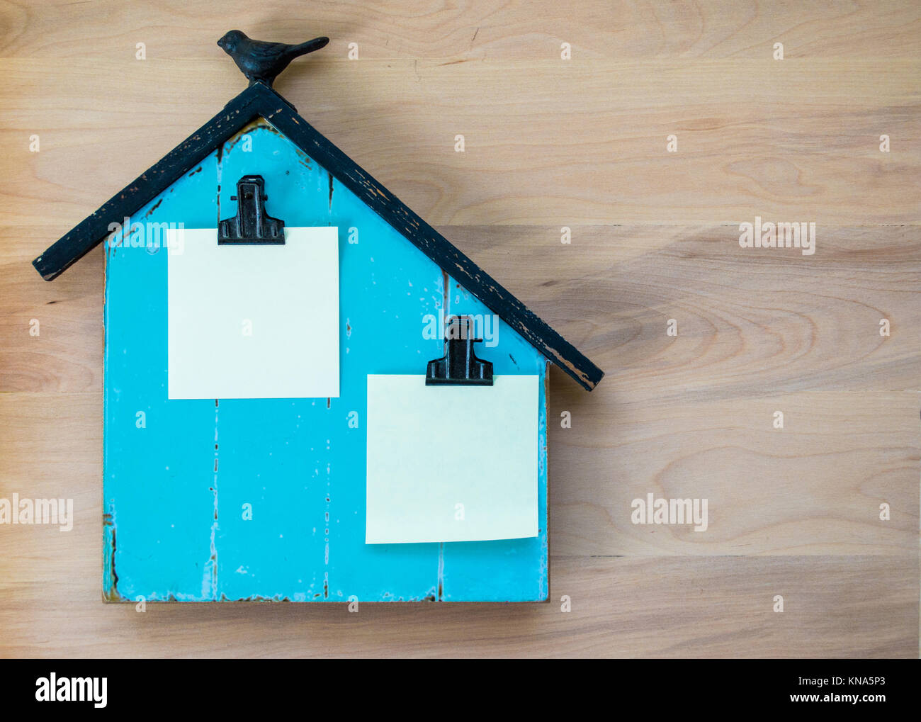 turquoise wooden memo board shaped like a barn with blank paper space